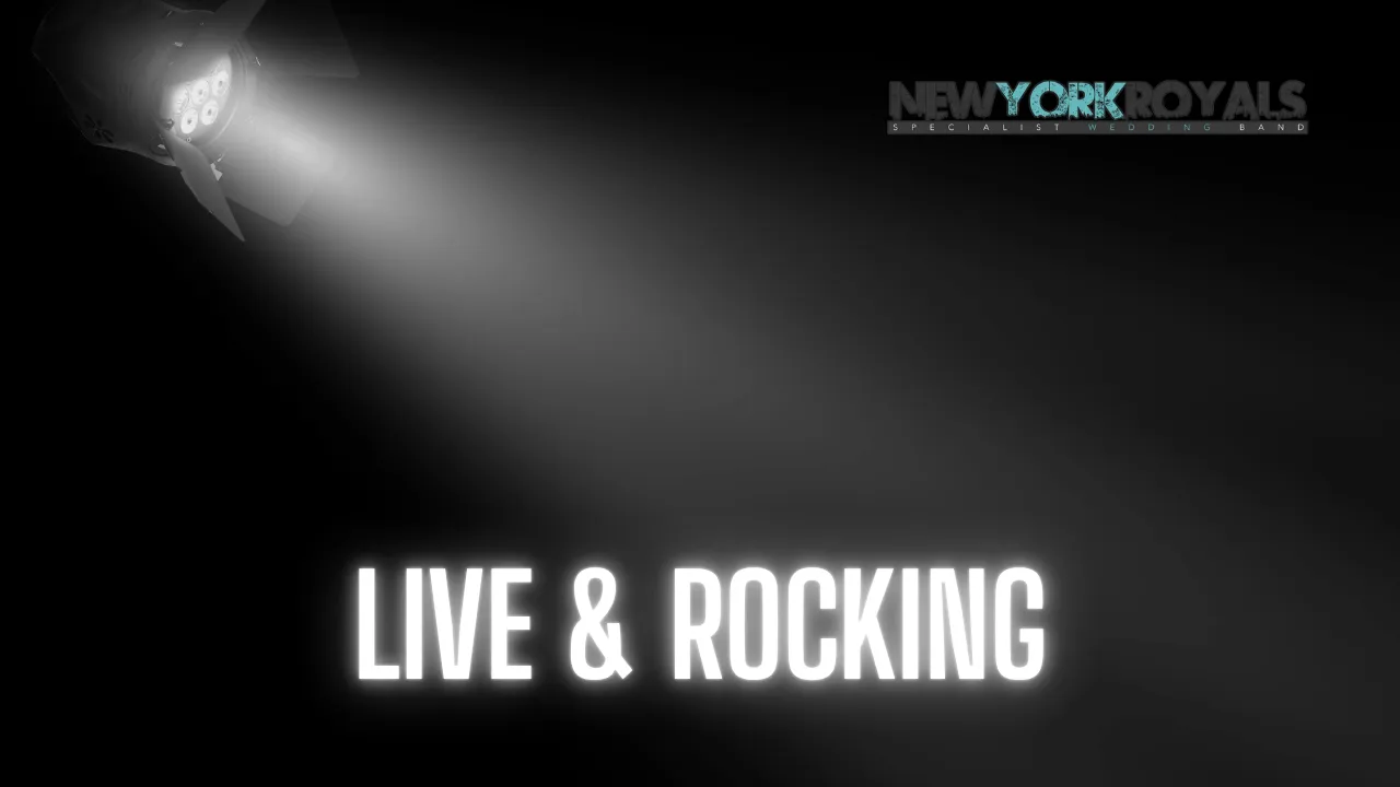 Single spotlight beaming down on a dark stage with text LIVE & ROCKING