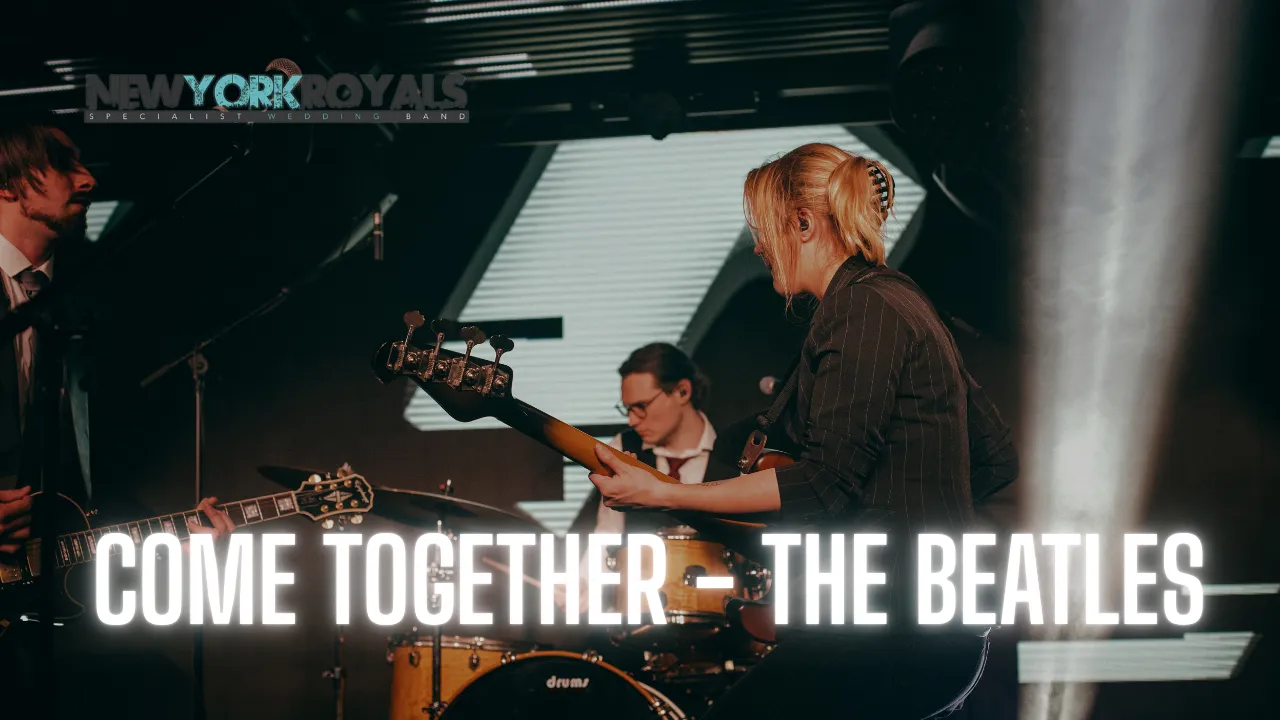 Band members performing live on stage under spotlights with text COME TOGETHER - THE BEATLES